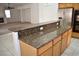 Kitchen island with granite countertop and wood cabinets at 1373 Blazing Sand St, Las Vegas, NV 89110