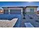 Single-story house with three-car garage and landscaped front yard at 163 Wildcat Ave, Pahrump, NV 89060