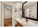 Bathroom vanity with white tiled countertop, wooden cabinets, and a mirror at 193 Webster Way, Henderson, NV 89074