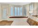 Bright bedroom featuring a bay window with a built-in window seat and plantation shutters at 193 Webster Way, Henderson, NV 89074