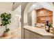 Wet bar with mosaic tile backsplash, wood shelving, and copper sink at 193 Webster Way, Henderson, NV 89074