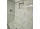 Clean shower with marble tile and penny round floor at 2208 Alisa Maria Way, Las Vegas, NV 89104