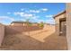 Gravel backyard with two trees and a view of neighboring homes at 2767 Lindsey Springs St, Las Vegas, NV 89142