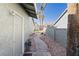 Landscaped side yard with a pathway leading to the back at 412 Vassar Ln, Las Vegas, NV 89107