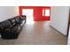 Living room with tile floor, red walls, and large sectional sofa at 6125 Blossom Knoll Ave, Las Vegas, NV 89108