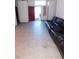 Living room with tile floor, red walls, and large sectional sofa at 6125 Blossom Knoll Ave, Las Vegas, NV 89108