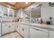 Bright eat-in kitchen with white cabinets and tile countertops at 9675 Summer Lilac Ct, Las Vegas, NV 89123