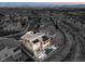 Aerial view of a luxury home with a pool and solar panels; beautiful mountain views at 12013 Glentana View St, Las Vegas, NV 89138