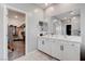 White double vanity in the bathroom with a view of the walk-in closet at 12404 Liberty Beacon Ave, Las Vegas, NV 89138