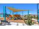 Playground with shade structure and bench at 1573 Dom River Dr # Lot 117, North Las Vegas, NV 89084