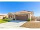 Single-story home with brown garage door and landscaped yard at 2540 Youngdale Dr, Las Vegas, NV 89134