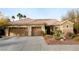 Inviting single-story home with tile roof, three-car garage, and desert landscaping at 427 Norridgewock St, Henderson, NV 89074