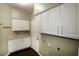 Laundry room with white cabinetry, folding counter, and exterior access at 427 Norridgewock St, Henderson, NV 89074