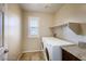 Bright laundry room with washer, dryer and shelving at 51 Sirius Ridge Way, Las Vegas, NV 89183