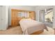 Bedroom with built-in wooden headboard and mirrored closet at 5125 W Reno Ave # 1047, Las Vegas, NV 89118