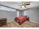 Bedroom with wood flooring, ceiling fan, and window at 5152 Tennis Ct # E, Las Vegas, NV 89120