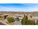 Aerial view of a luxury home with a modern design and mountain views at 6160 Banded Stones Ct, Las Vegas, NV 89135