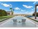 Modern infinity pool and seating area with a view at 6160 Banded Stones Ct, Las Vegas, NV 89135