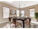 Virtually staged dining room with a dark wood table and six chairs at 6205 Red Pine Ct, Las Vegas, NV 89130