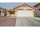 Single story home with a two-car garage and desert landscaping at 7664 Little Valley Ave, Las Vegas, NV 89147