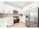 Modern kitchen with stainless steel appliances and white cabinetry at 8833 Square Knot Ave, Las Vegas, NV 89143