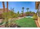 Backyard oasis with lush green lawn and pool at 9421 Wisdom Valley Ave, Las Vegas, NV 89149