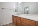 Bathroom boasts double sinks and wood cabinets at 9421 Wisdom Valley Ave, Las Vegas, NV 89149