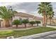 Single-story house with a three-car garage, lush landscaping, and palm trees at 9833 Masterful Dr, Las Vegas, NV 89148