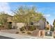 Attractive single-story home with tan colored exterior and landscaping at 9876 Cullin Range Ave, Las Vegas, NV 89166