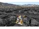 Aerial view of a house in a residential neighborhood with mountain views at 10522 Arnica Way, Las Vegas, NV 89135