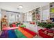 Colorful playroom with built-in shelving, and two ' tables at 10522 Arnica Way, Las Vegas, NV 89135