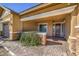 Covered entryway with a stone facade and a charming front door at 10534 Riley Cove Ln, Las Vegas, NV 89135