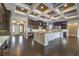 Gourmet kitchen with dark wood cabinets, granite island, and high ceilings at 10534 Riley Cove Ln, Las Vegas, NV 89135