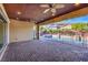 Covered patio with brick pavers and views of the pool and mountains at 10534 Riley Cove Ln, Las Vegas, NV 89135