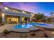 Expansive pool and spa area with a large patio and lush landscaping at 10644 San Vercelli Ct, Las Vegas, NV 89141