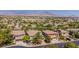 Aerial view of a residential neighborhood with houses and mountain views at 133 S Buteo Woods Ln, Las Vegas, NV 89144