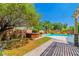 Landscaped backyard oasis with pool and hot tub at 133 S Buteo Woods Ln, Las Vegas, NV 89144