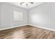 Simple bedroom with wood-look floors and a window with shutters at 133 S Buteo Woods Ln, Las Vegas, NV 89144