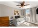 Cozy bedroom with a day bed, large window, and ceiling fan at 1838 Tee Box Way, Henderson, NV 89074