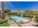 Inviting pool with a waterfall feature, landscaping, and a statue at 2024 Troon Dr, Henderson, NV 89074