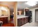 Kitchen with dark wood cabinets, black appliances, and granite countertops at 2451 N Rainbow Blvd # 2082, Las Vegas, NV 89108