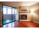 Fireplace in living room with sliding glass door to balcony and wood-look floors at 2451 N Rainbow Blvd # 2082, Las Vegas, NV 89108