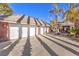 Three-car garage with white doors and a large concrete driveway at 2508 Rancho Bel Air Dr, Las Vegas, NV 89107