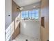 Walk-in shower with wood-paneled walls and marble accents at 2914 Congress Ave, Las Vegas, NV 89121