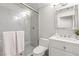 Clean bathroom with white vanity, frameless shower, and marble tile at 5062 Mount Pleasant Ln, Las Vegas, NV 89113