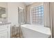 Relaxing bathroom with a large soaking tub and a window with privacy glass blocks at 5062 Mount Pleasant Ln, Las Vegas, NV 89113