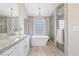 Spa-like bathroom featuring a soaking tub, walk-in shower, and granite vanity at 5062 Mount Pleasant Ln, Las Vegas, NV 89113