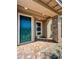 Home exterior featuring a teal front door, brick paver walkway, and stone column at 712 Cottonwood Hill Pl, Henderson, NV 89011