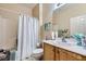 Clean bathroom with a shower/tub combo and wood vanity at 7616 Fruit Dove St, North Las Vegas, NV 89084