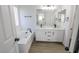 Modern bathroom with soaking tub, double vanity, and walk-in shower at 7769 Somerhill Point Way, Las Vegas, NV 89139